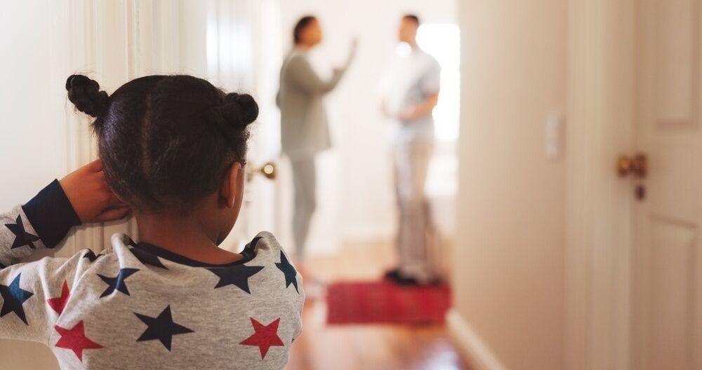 Divorce, fight and back of child in family home for conflict, disagreement and custody battle. Relationship crisis, frustrated and anger with kid watching parents in hallway of house for break up